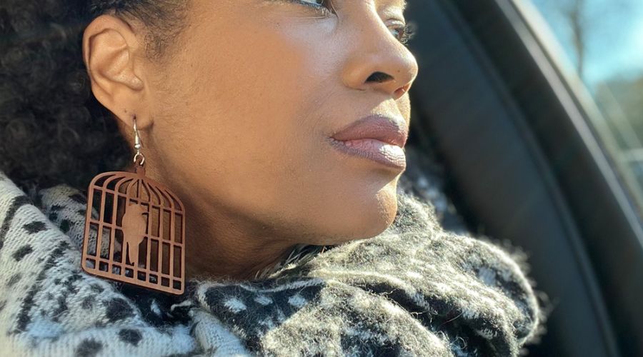 Mia modeling bird cage earrings